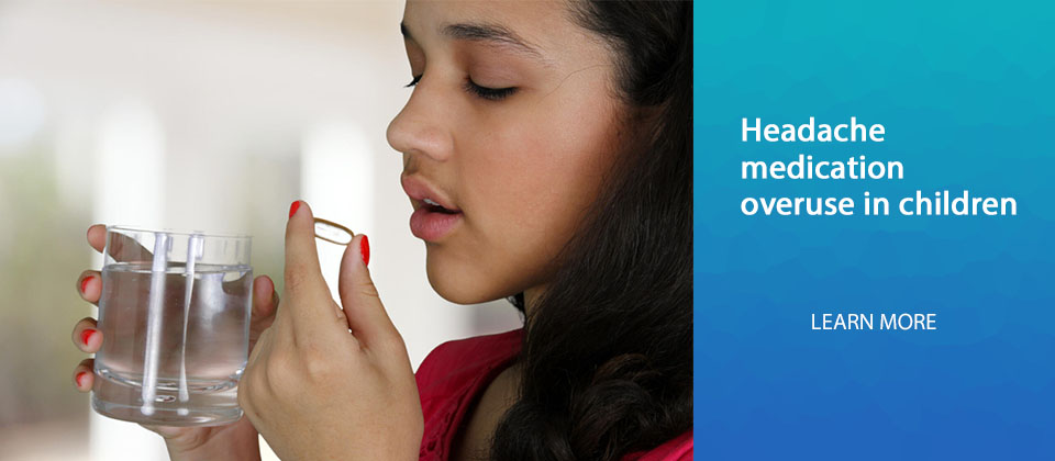 Teenage girl takes pill with glass of water