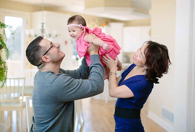 Parents holding their baby up