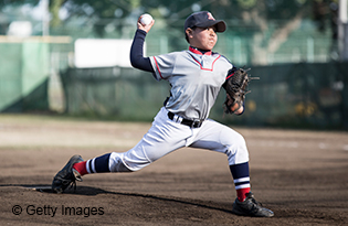 Young baseball player pitching a ball