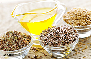 Bowls of whole and ground flax seed with linseed oil