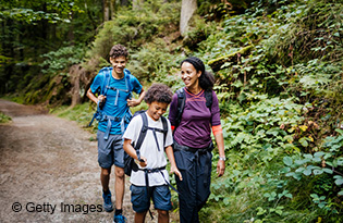 Family hiking a wooded trail