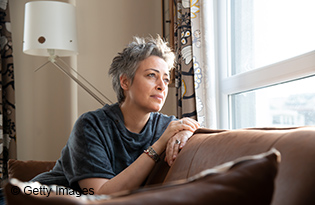 Woman looking out the window at home